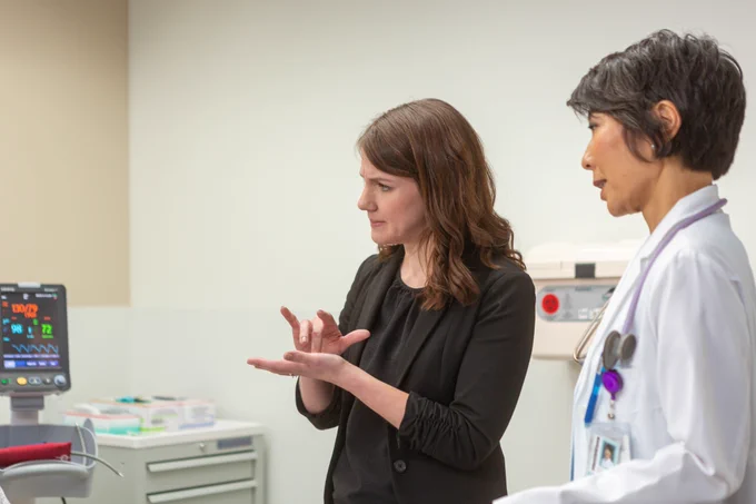 Interpreter interpreting patient-provider conversation in hospital setting