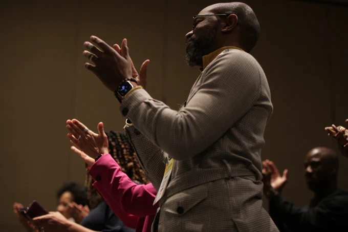 an image of people clapping in a crowd