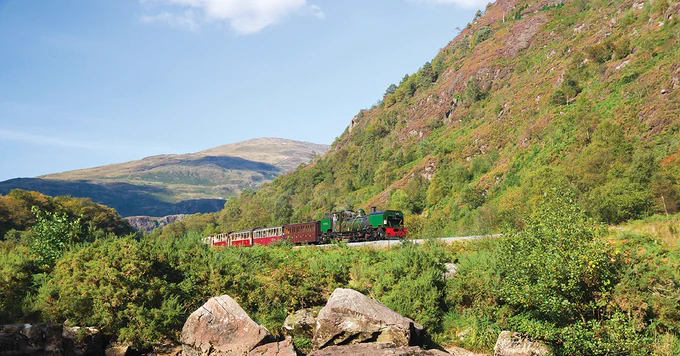 Train amongst green mountains