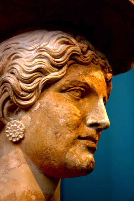 An ancient Greek statue of a female profile turning right 
