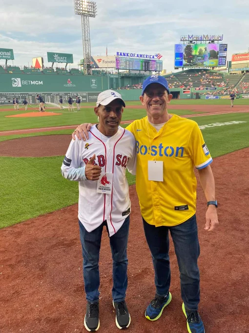 Two men on the field at Fenway Park.