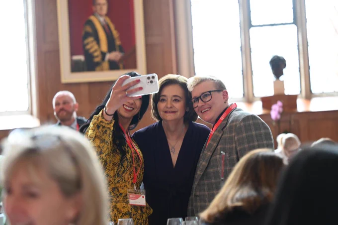 Cherie Blair taking selfies with guests.