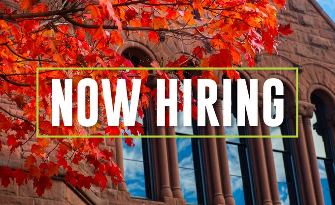 Promotional image for job opportunities at the Gund Institute for Environment at the University of Vermont (UVM). The image consists of the words "Now Hiring" on top of a photo that features a historic campus building and red fall foliage.