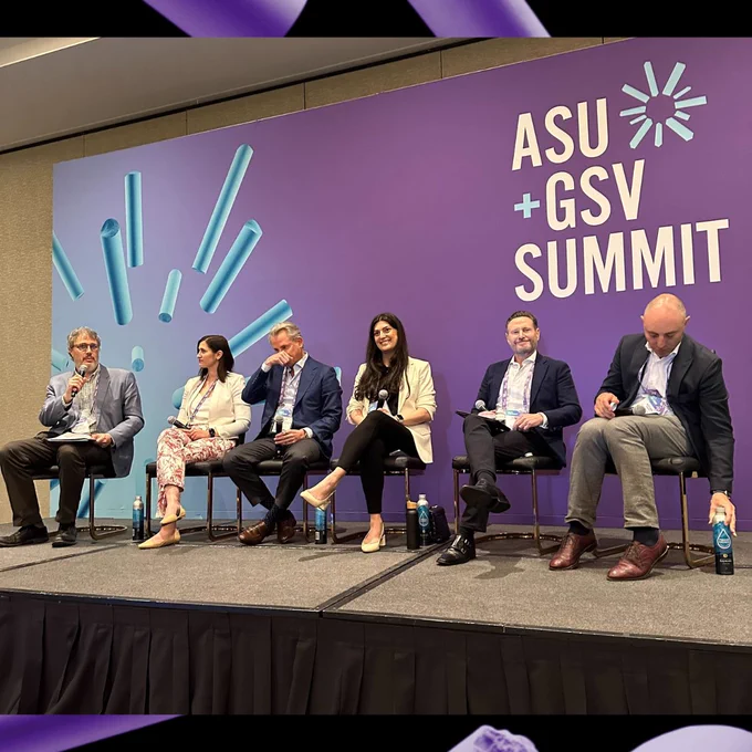 Narine sits in the center of the ASU GSV panelists smiling and holding the microphone. 