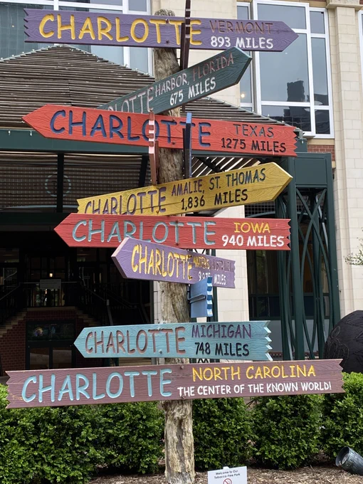 Signs of towns named Charlotte from different states.