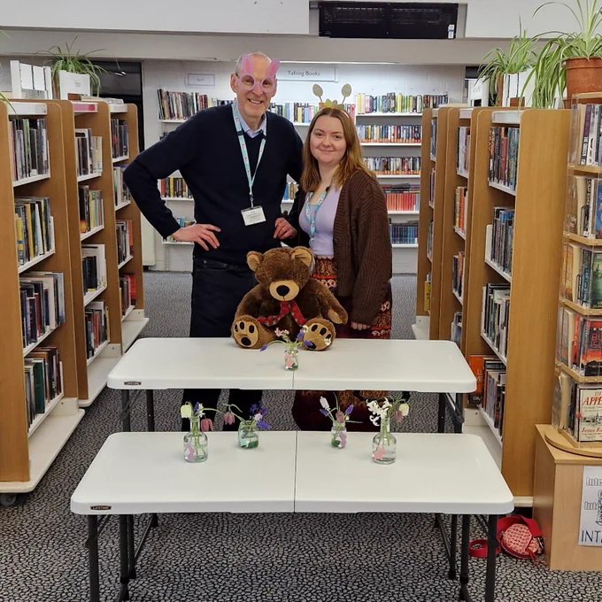 two staff members stood behind tables