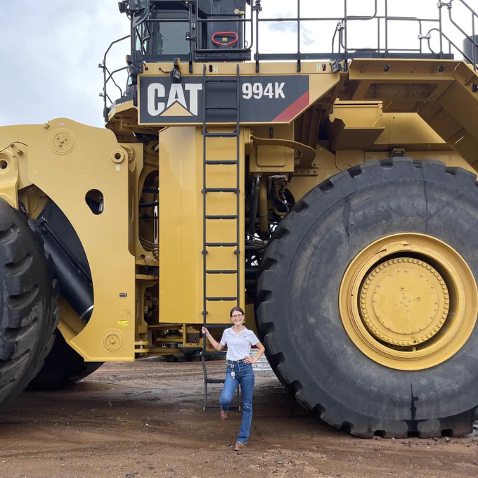 Kasey Spradling in front of a CAT Construction vehicle