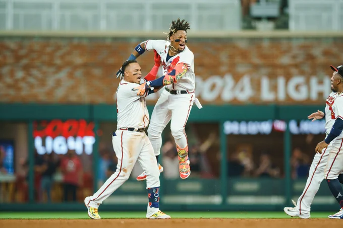Orlando Arcia and Ronald Acuña celebrate after Arcia's walk-off hit.