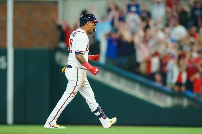Orlando Arcia looks at the Braves dugout and yells in celebration after his walk-off hit.