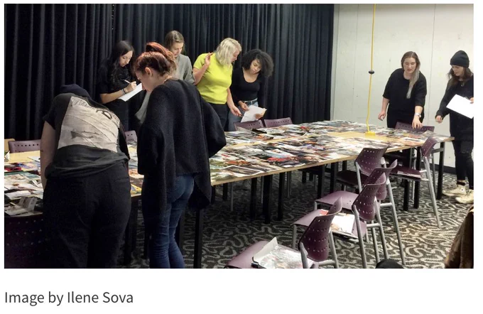 photo of people around a table looking at papers