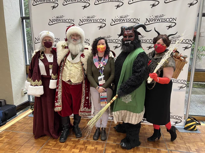 Picture of Anna posing with mrs Claus, Santa, krampus and lady krampus
