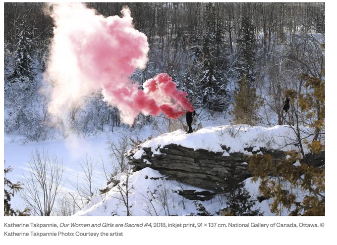 photograph of person with red smoke on snowy outdoor scene