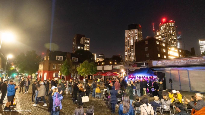 Vauxhall business at night with people outside