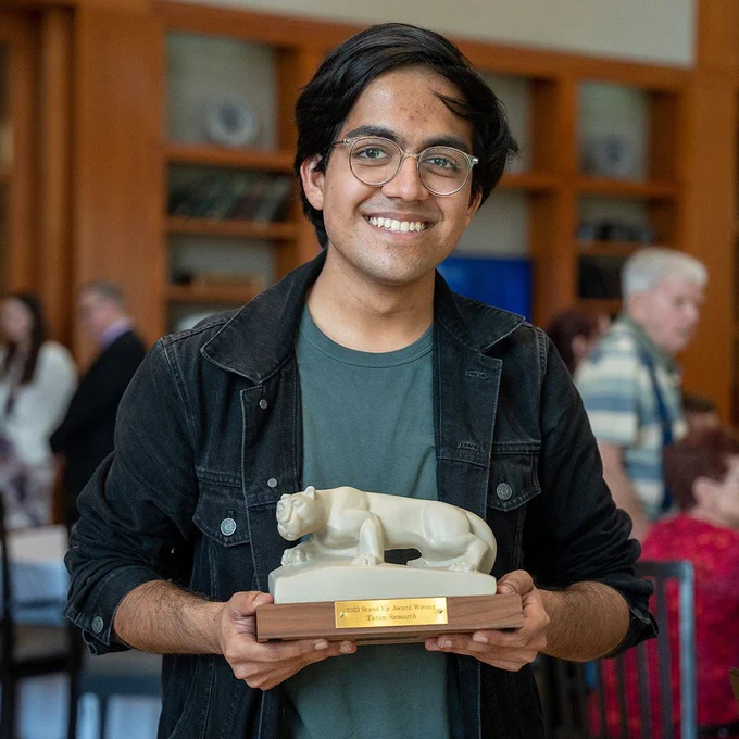 Taran Samarth holds his 2023 Stand Up Award