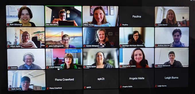Smiling faces on a zoom call.