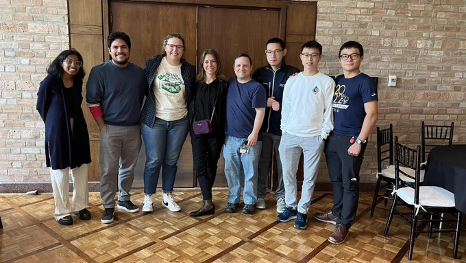 Graduate students pose with Professor Fabris after lunch