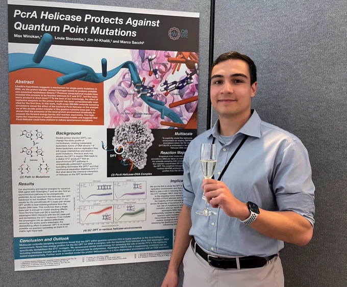 A photograph of the prize winner next to the winning poster
