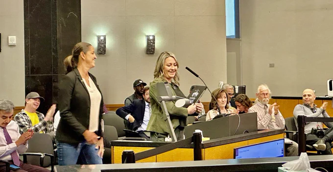 Two people at the podium reading a proclamation.