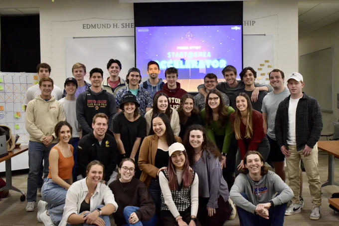 Group picture of Maggie and the 2023 Start@Shea accelerator cohort in the Shea Center room on Boston College’s campus.