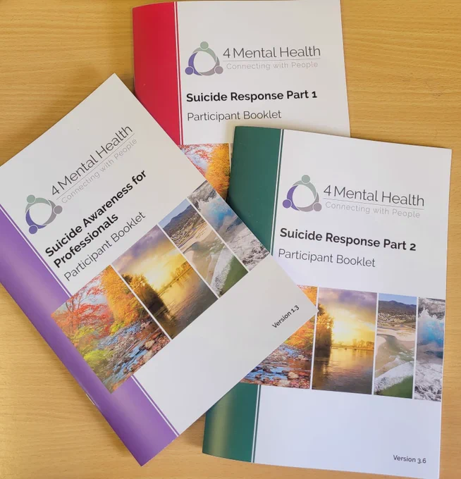 Photo taken of Suicide Awareness, Suicide Response Part 1 and Suicide Response Part 2 training booklets, developed by 4 Mental Health