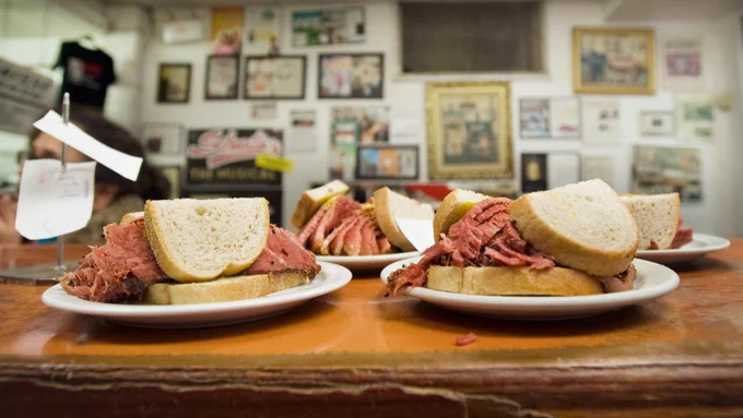 ALT Smoked meat sandwiches sit on the wooden countertop at Schwartz's deli in Montreal. Photo credit Graham Hughes/CP