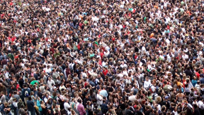 A wide shot photo of a very large crowd.