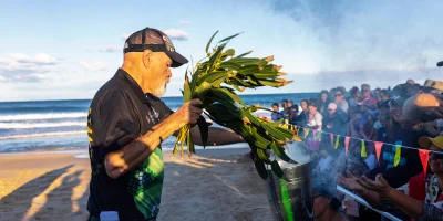 Barry Duncan, Chair of the Darkinjung Aboriginal Land Council, performs a smoking ceremony on Shelly Beach on the Central Coast