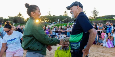 Taronga Zoo Cultural Representative Suzanna Boyd shakes hands with Barry Duncan, Chair of Darkinjung Aboriginal Land Council on Shelly Beach on the Central Coast