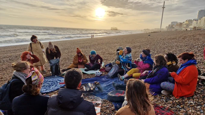 "Singing to the Lovely Dead", an event hosted by Christina Watson on Brighton beach. 