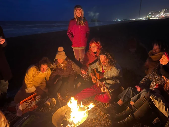 "Singing to the Lovely Dead" around a campfire on the beach, an event hosted by Christina Watson.