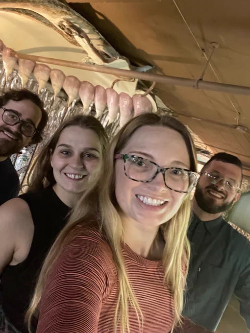 Joshua Raebel, Libby Stokes, Tyler Brady, and Michaela Bell are smiling inside a City Musuem exhibit.