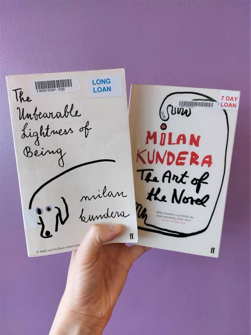 A hand holds Milan Kundera's The Unbearable Lightness of Being and The Art of the Novel, against a bright purple wall