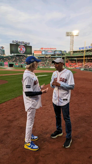 Emmanuel College President Mary K. Boyd and 2014 Boston Marathon winner and Olympic Silver Medalist Meb Keflezighi on the field at Fenway Park.