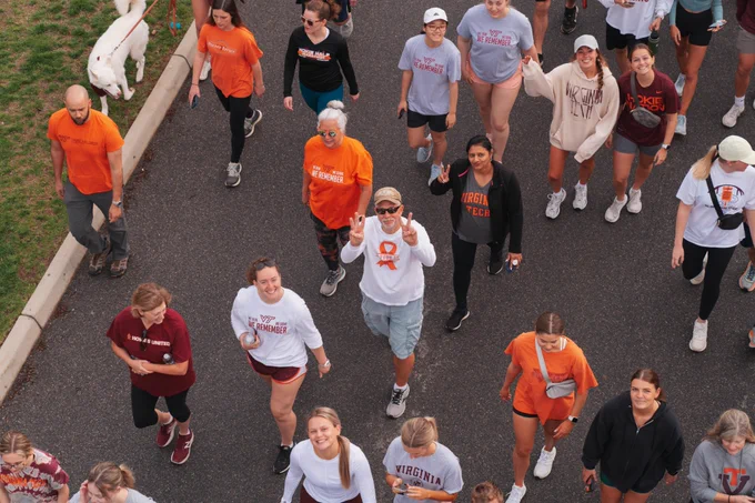 An overhead image depicts participants in the 3.2-Mile Run in Remembrance posing while walking on Alumni Mall.