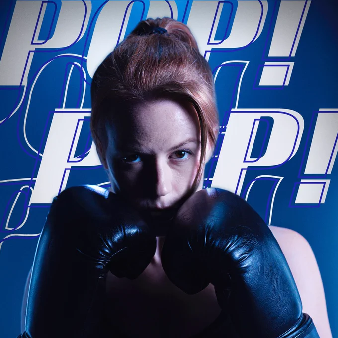 Marisha Ray poses in boxing gloves in front of text reading Pop! Pop! Pop! Pop!