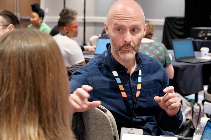 Attendees take turns interviewing each other in a hands-on exercise.
