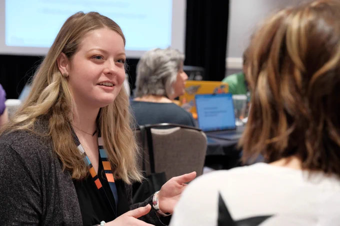 Attendees take turns interviewing each other in a hands-on exercise.