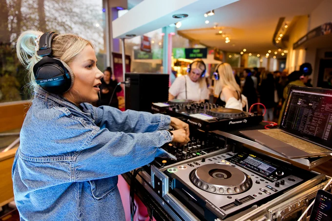 Special guest Kate Lawler in front of the DJ booth, playing tracks for the silent disco as the crowd dances.