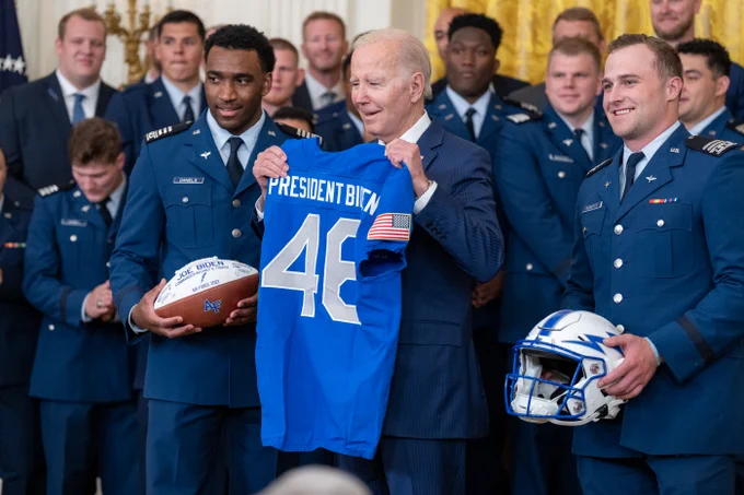 The AIr Force Falcons present a jersey to President Biden 