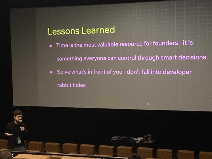 Wix Developer Advocate Thomas Jimenez speaking at HalfStack conference in Charlotte.

Screen title says "Lessons Learned" with 2 bullet points reading:

1. "Time is the most valuable resource for founders - it is something everyone can control through smart decsions."

2. "Solve what's in front of you - don't fall into developer rabbit holes."