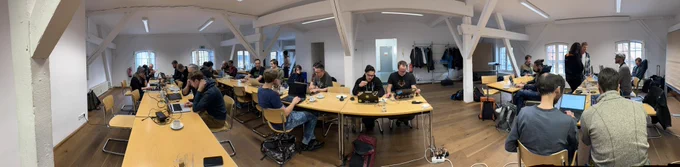 People setting on tables and working on Neos CMS