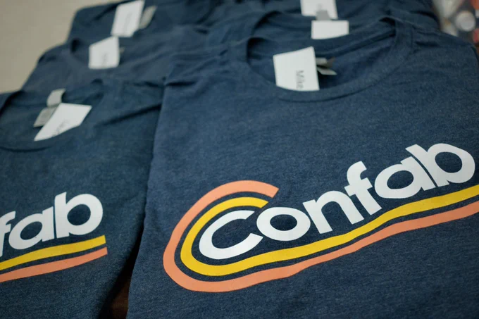 Piles of Confab t-shirts displayed.