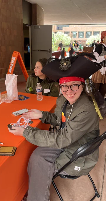 Student dressed as pirate untangling strings