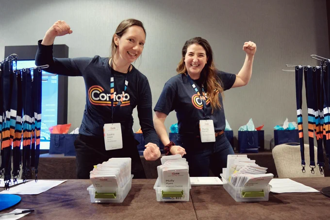 Confab volunteers flex at the registration desk.