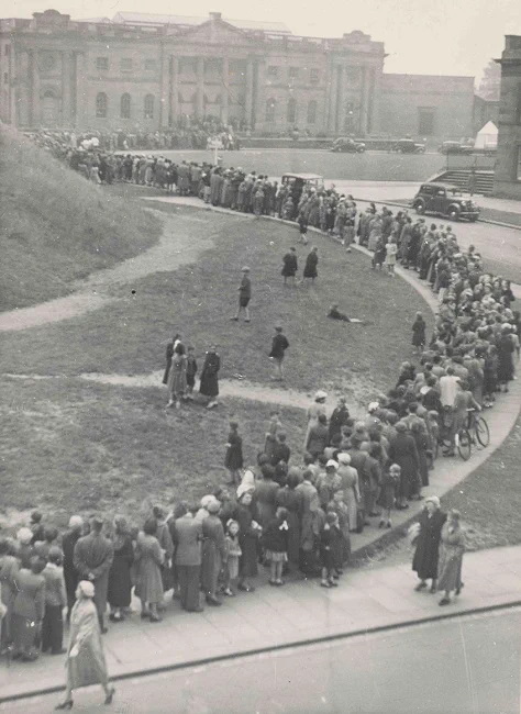 Black and white photograph showing long queues of people waiting to gain entry to York Castle Museum 