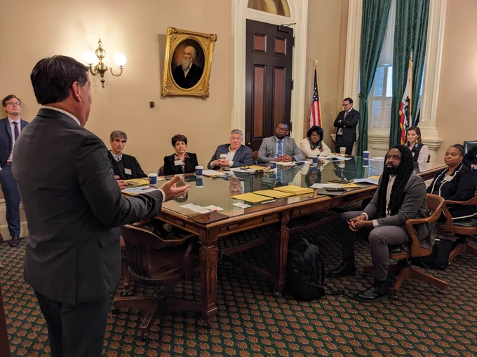 Assemblymember Grayson speaks to CDFI representatives around a table in the California State Capitol