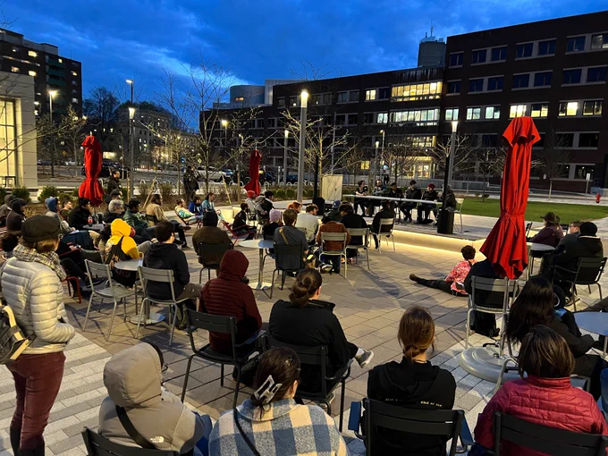 Various local Boston Indies sitting in the MIT Open Space and freezing in the April evening chill while listening to a fun panel!