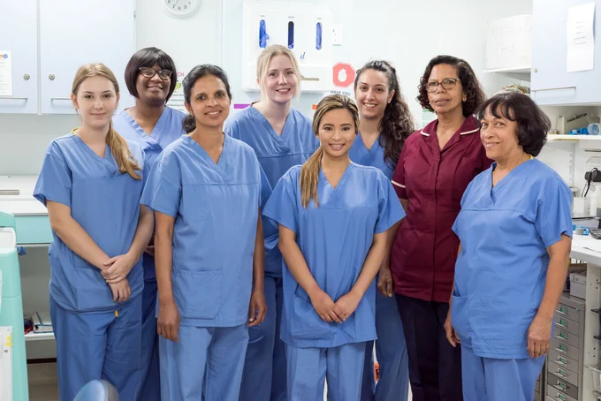 Photograph of a group of nurses dressed in hospital scrubs.