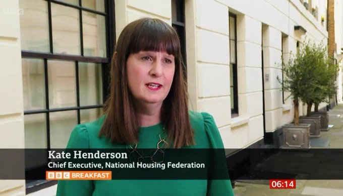 Screenshot of Kate Henderson in from of houses speaking on BBC Breakfast on BBC1