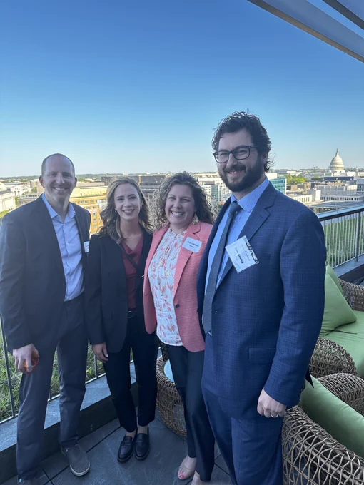 Group photo on balcony with Washington DC in the background